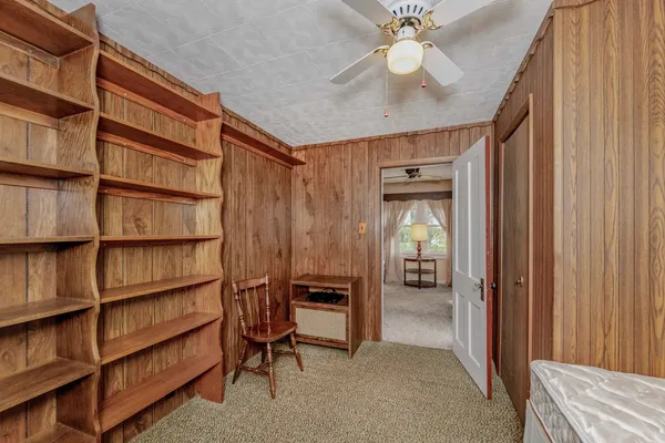 a view of bedroom with a ceiling fan