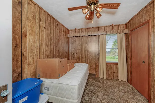 a bedroom with a bed and a chandelier