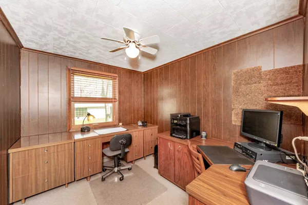 a view of a workspace with furniture and a window