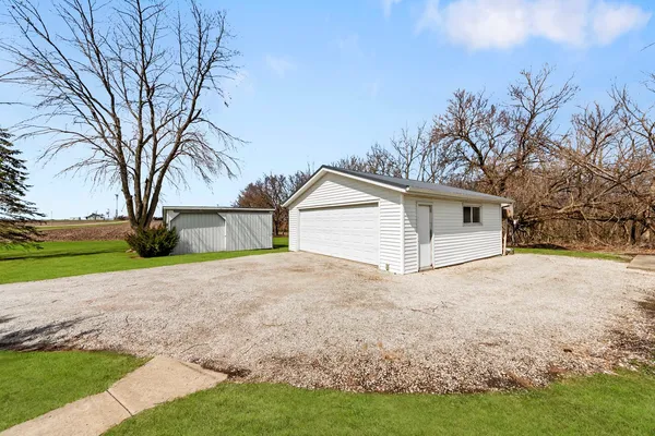 a view of a house with a yard and garage