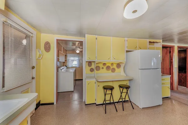 a room with a refrigerator and a table