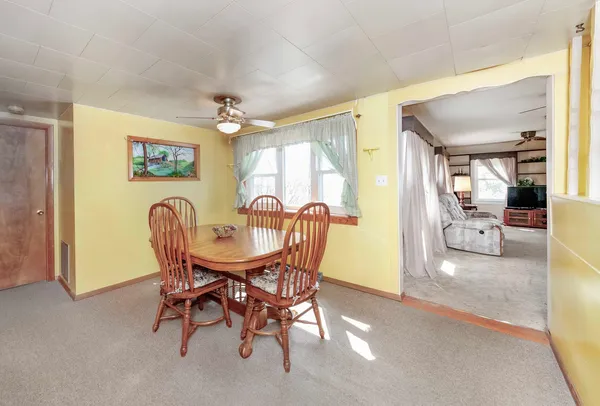 a view of a dining room with furniture and a chandelier