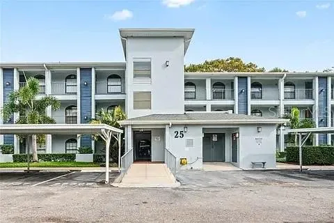 a front view of a residential apartment building with a yard