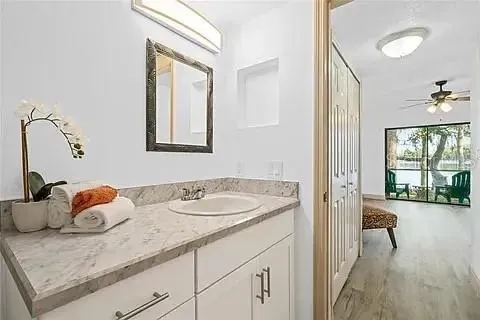 a bathroom with a granite countertop sink mirror and vanity