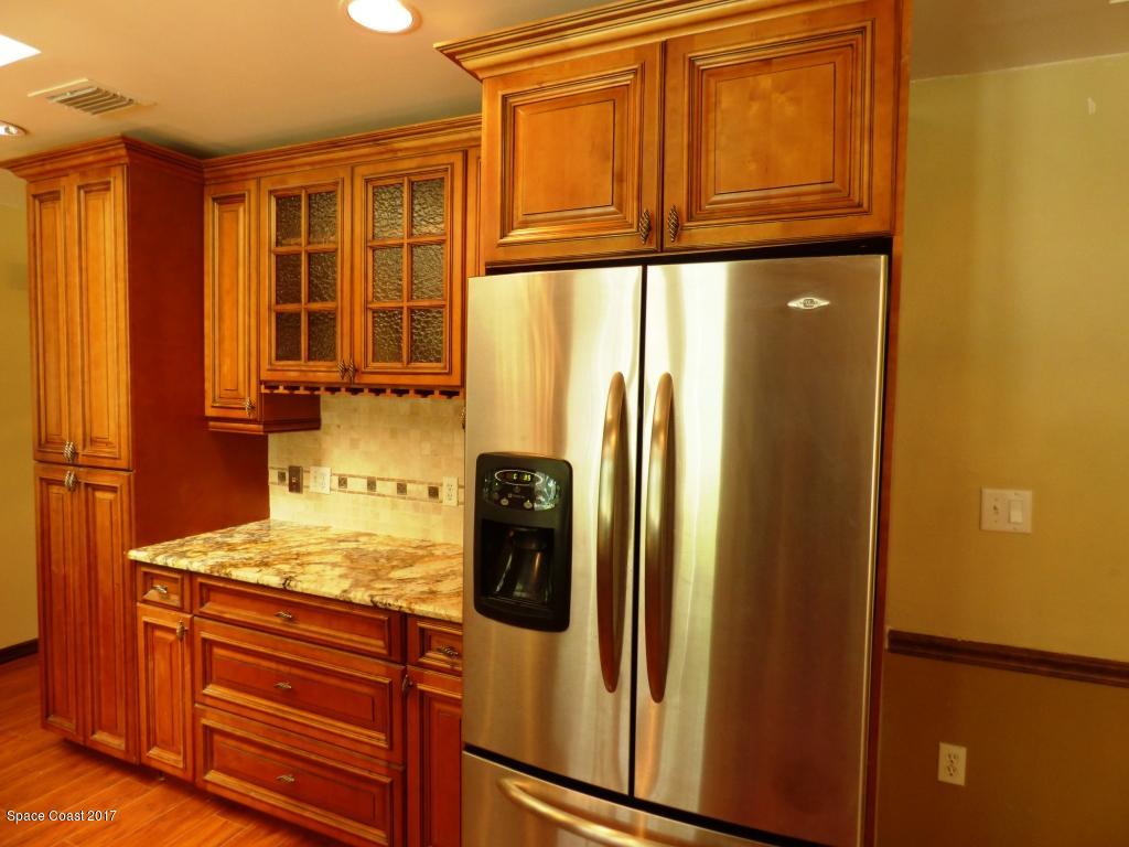 1315 Northeast Tropicana Road Palm Bay, FL 32905 - Photo 14 of 49 a view of a refrigerator and a window