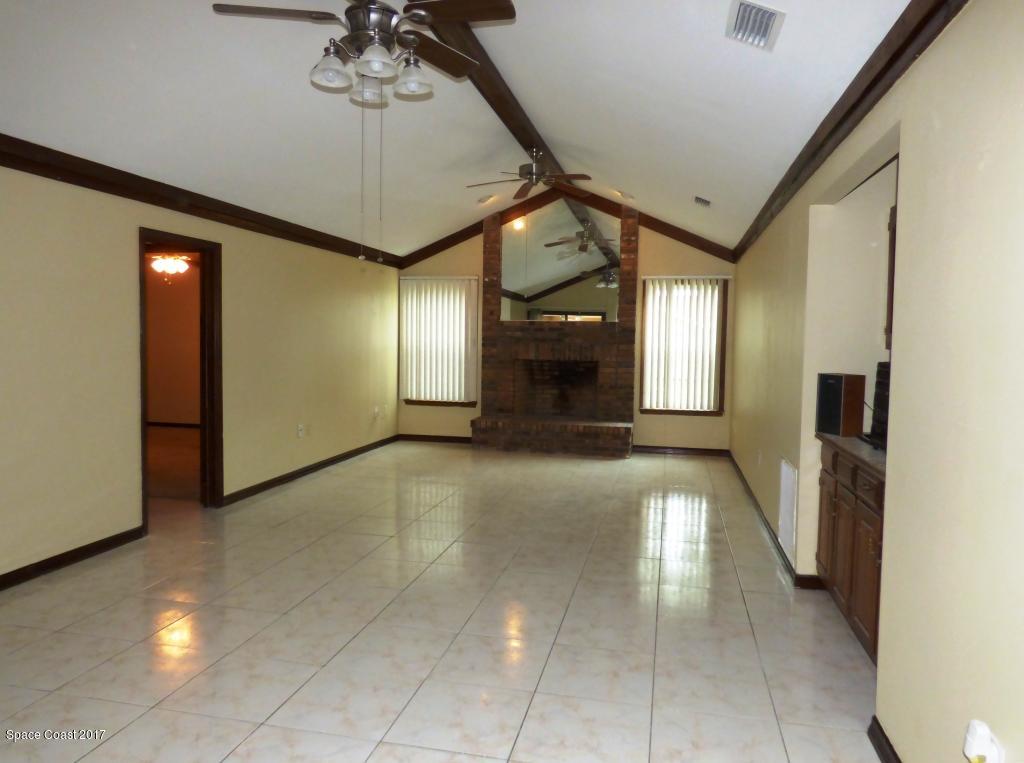 1315 Northeast Tropicana Road Palm Bay, FL 32905 - Photo 22 of 49 a view of a hallway with a chandelier