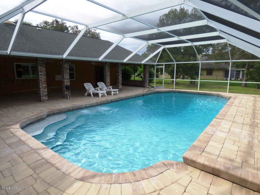 1315 Northeast Tropicana Road Palm Bay, FL 32905 - Photo 40 of 49 a view of a swimming pool with a patio