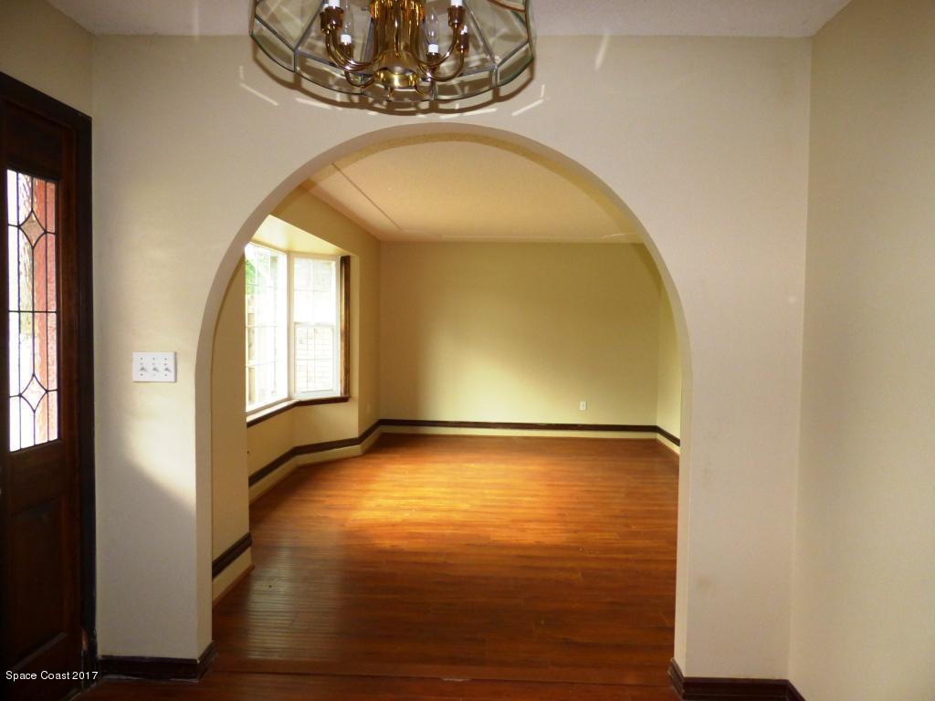 1315 Northeast Tropicana Road Palm Bay, FL 32905 - Photo 8 of 49 a view of an empty room with window and wooden floor