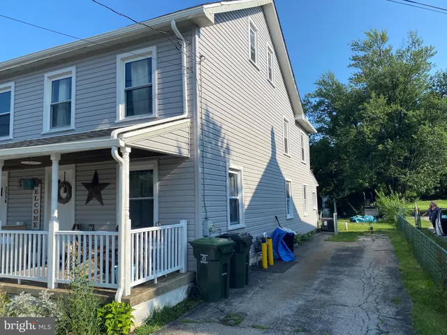 a view of a house with a yard and a floor to ceiling window