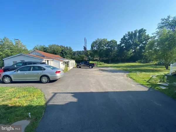 a view of a street with a car parked in the background