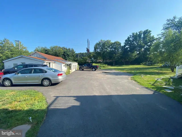 a view of a street with a car parked in the background