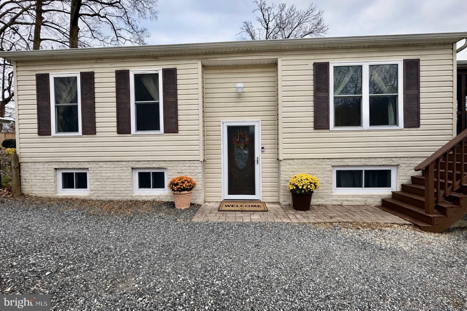 3906 1st Street North Beach, MD 20714 - Photo 1 of 4 a view of a house with a window and fire pit