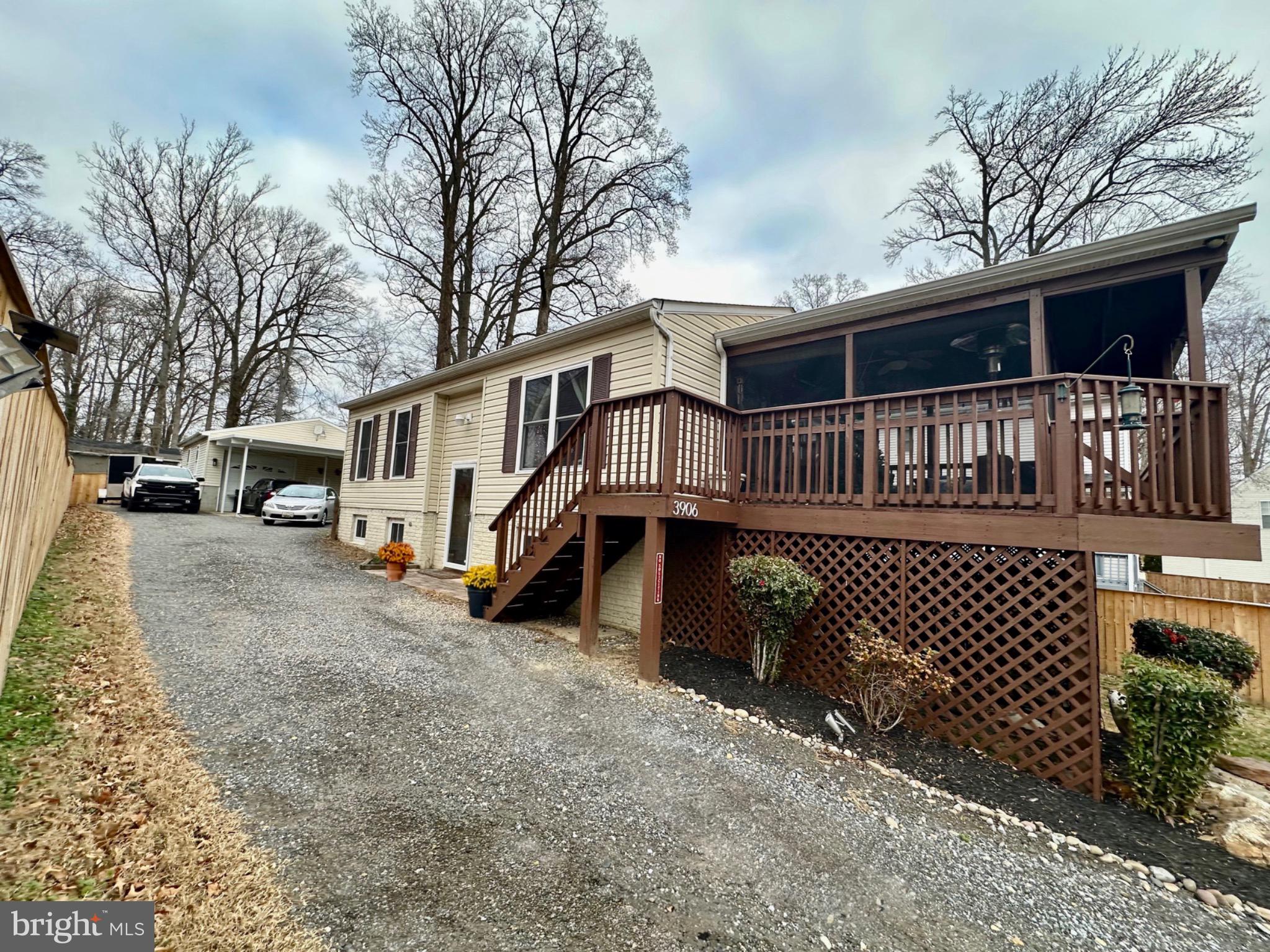 3906 1st Street North Beach, MD 20714 - Photo 2 of 4 a front view of a house with parking space