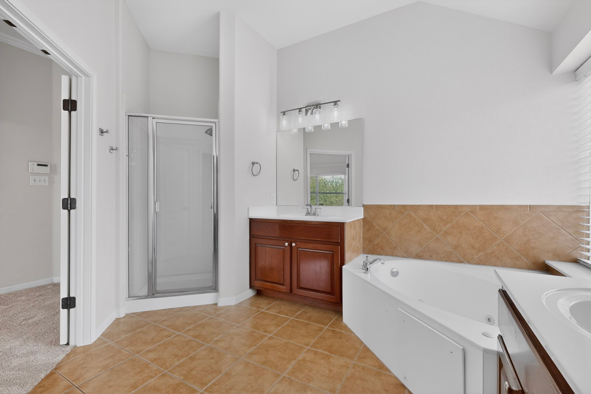 8617 Cobblestone Austin, TX 78735 - Photo 24 of 39 a bathroom with a tub sink and mirror