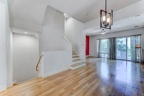 a view of a room with wooden floor and bathroom
