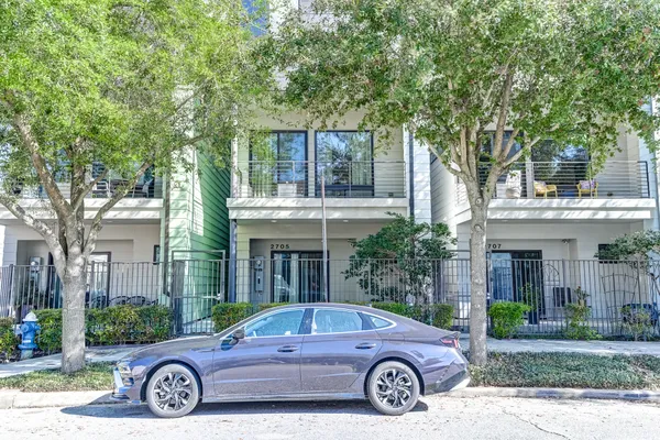 a car parked in front of a brick house