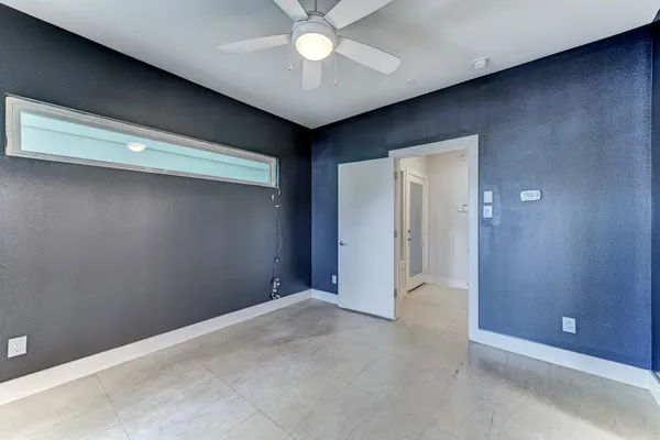 a view of a livingroom with a ceiling fan wooden floor and a ceiling fan