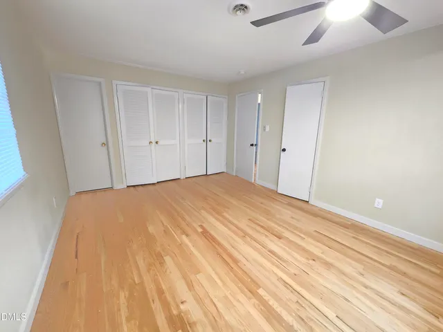 a bedroom with a bed and a ceiling fan