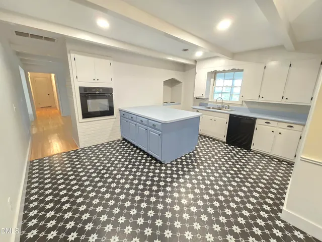 a living room with a bathtub and a potted plant