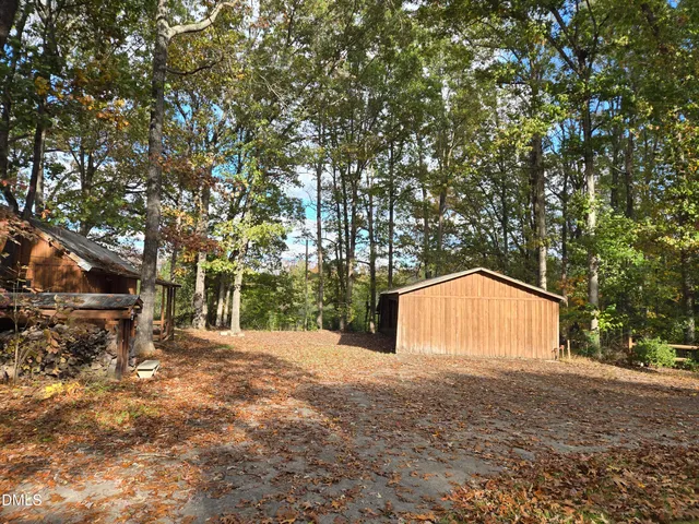 a view of backyard of house with green space