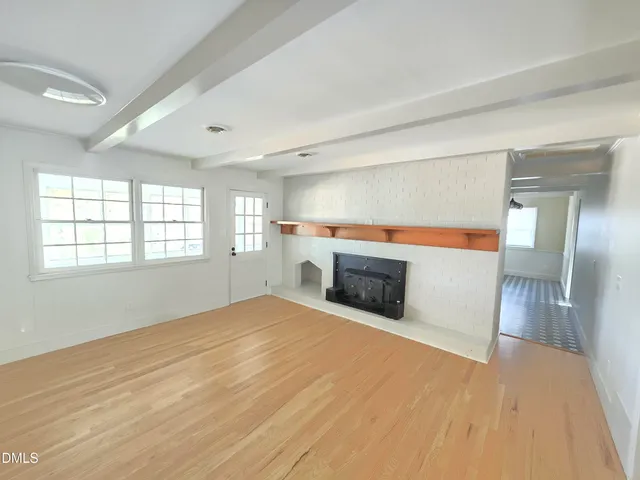 a view of empty room with a fireplace
