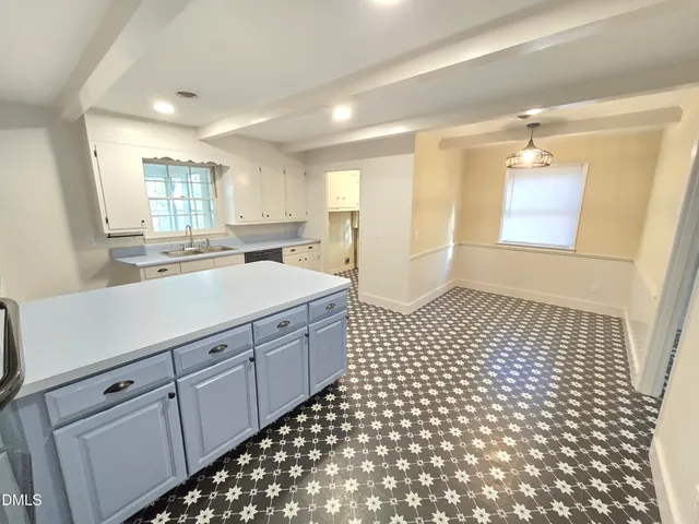 a bathroom with a sink a mirror and a shower