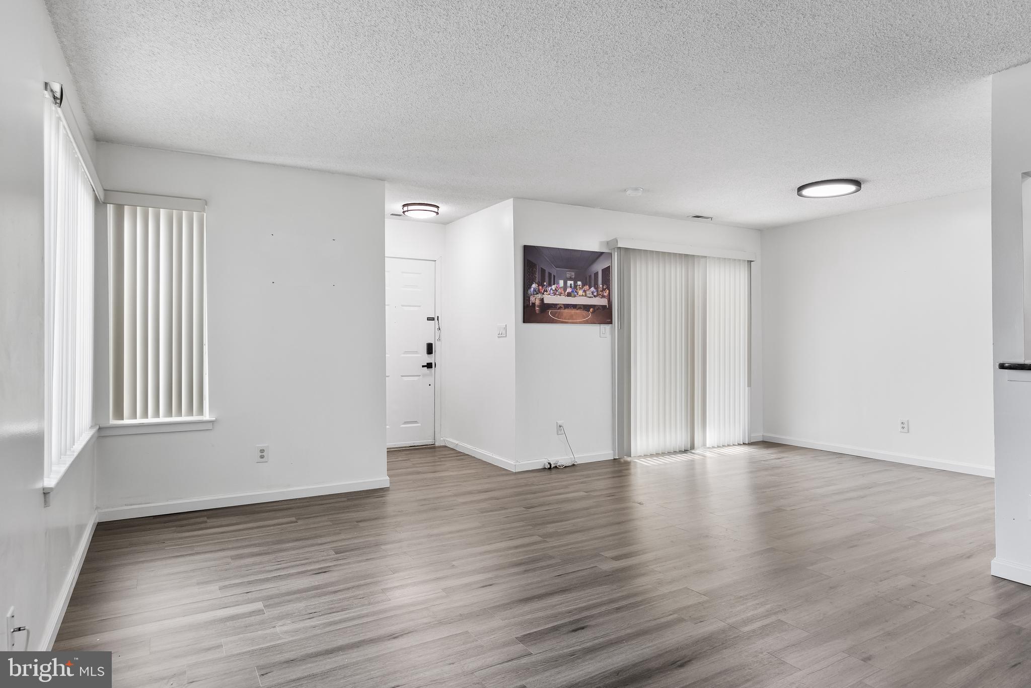 117 Sandra Road Voorhees, NJ 08043 - Photo 8 of 25 an empty room with wooden floor and windows