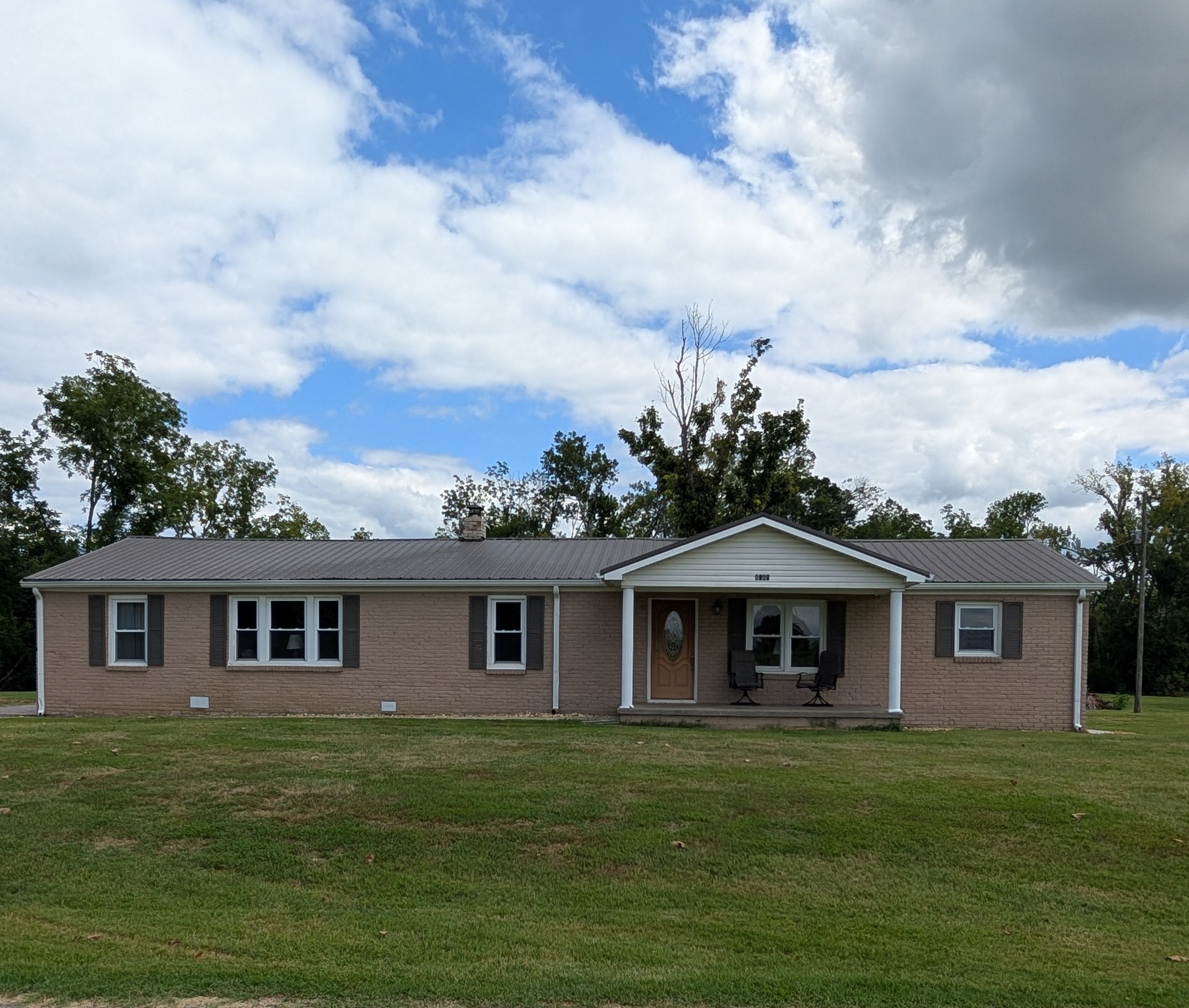 a front view of a house with a garden
