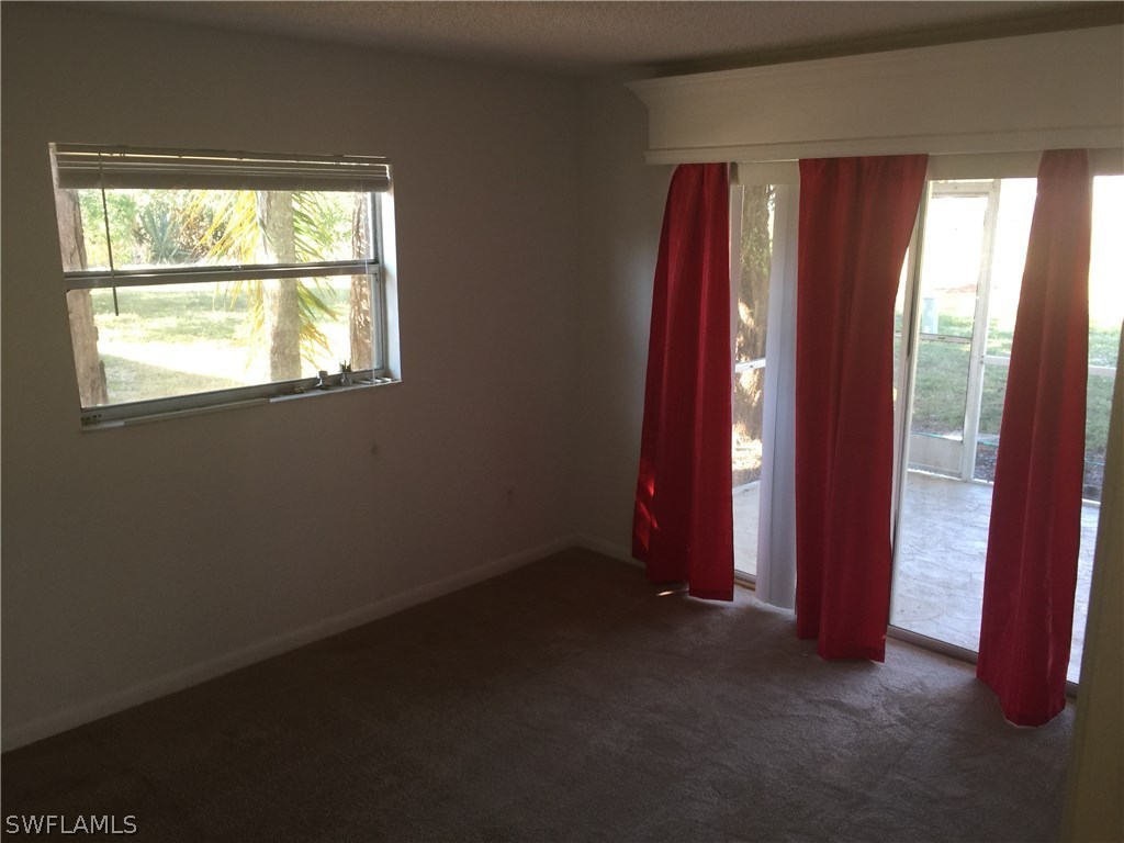 7449 Pebble Beach Road Fort Myers, FL 33967 - Photo 8 of 21 an empty room with windows and closet