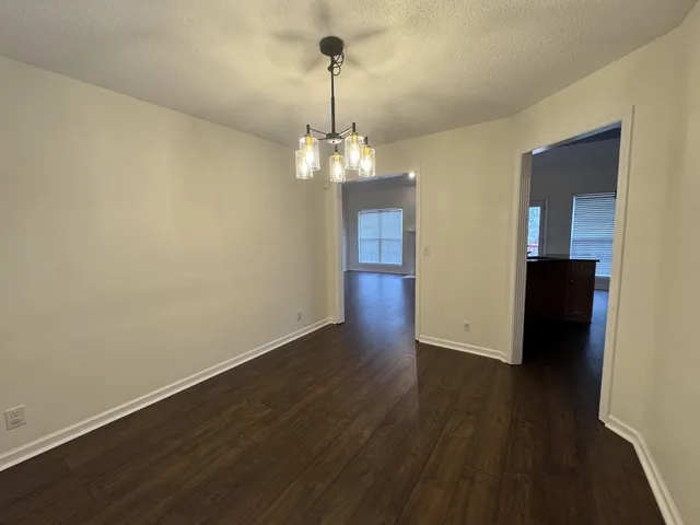 a view of a room with wooden floor and staircase