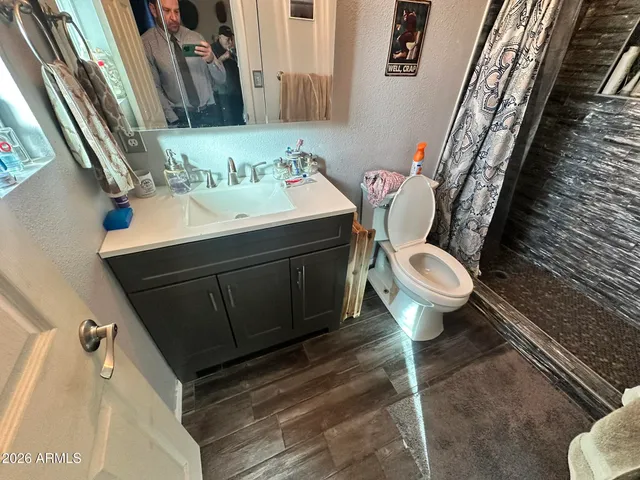 a bathroom with a sink toilet and mirror