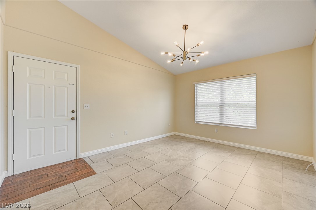 7255 West Sunset Road, Unit 2005 Las Vegas, NV 89113 - Photo 11 of 27 A well-lit entry welcomes with a vaulted ceiling and a blend of wood and tile flooring.