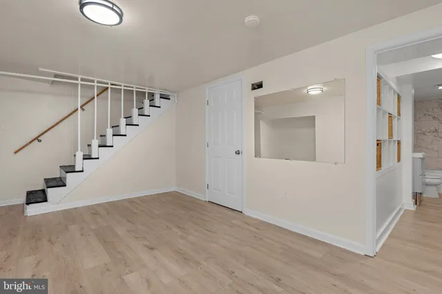 a view of entryway and hall with wooden floor