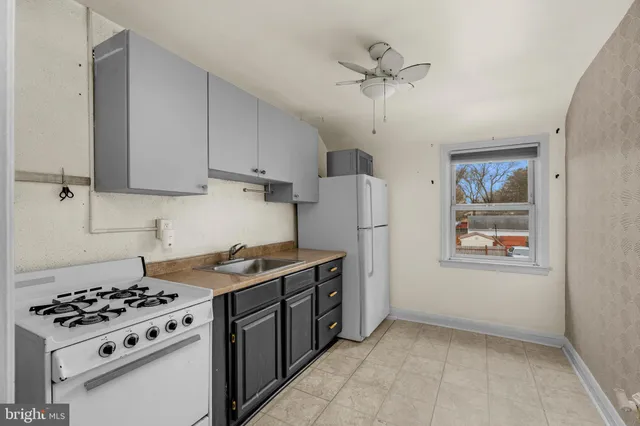 a kitchen with stainless steel appliances a stove a refrigerator and a sink