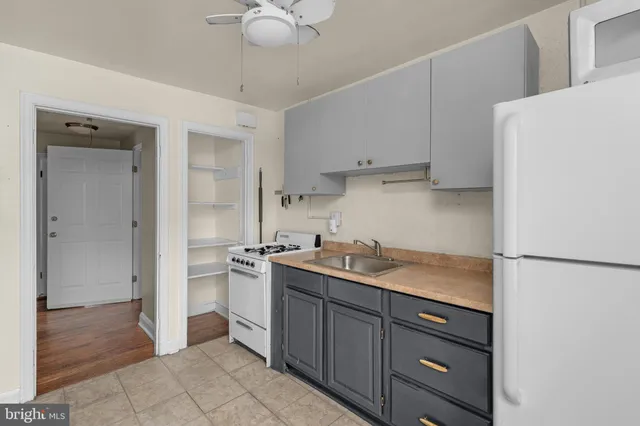 a kitchen with a sink a stove and refrigerator