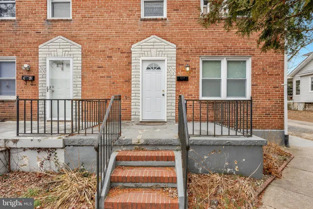 a view of a brick house with many windows