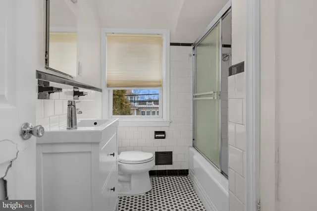 a white toilet sitting next to a bathroom sink