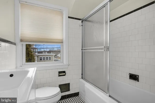 a bathroom with a toilet a sink and shower