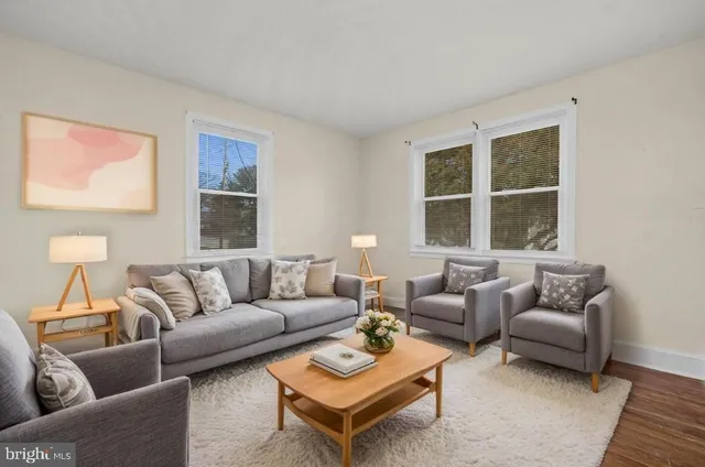 a living room with furniture a large window and a flat screen tv