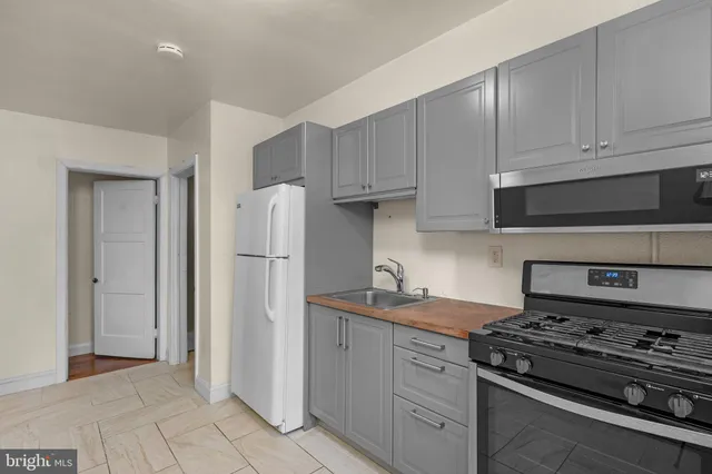 a kitchen with a stove and a refrigerator
