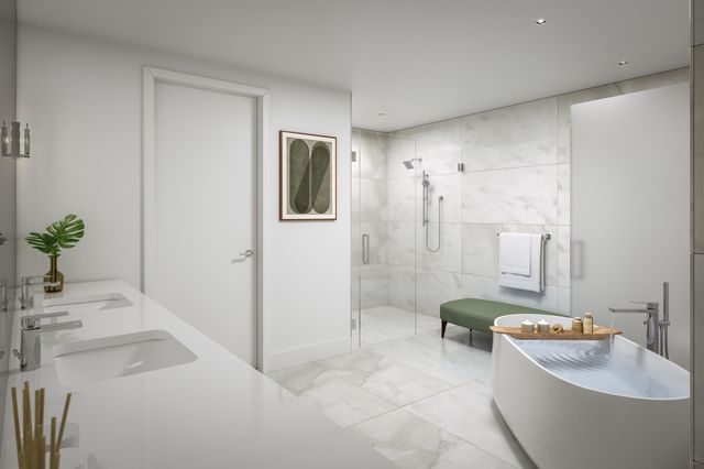 a bathroom with a tub a sink and mirror