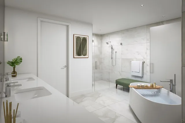 a bathroom with a tub a sink and mirror