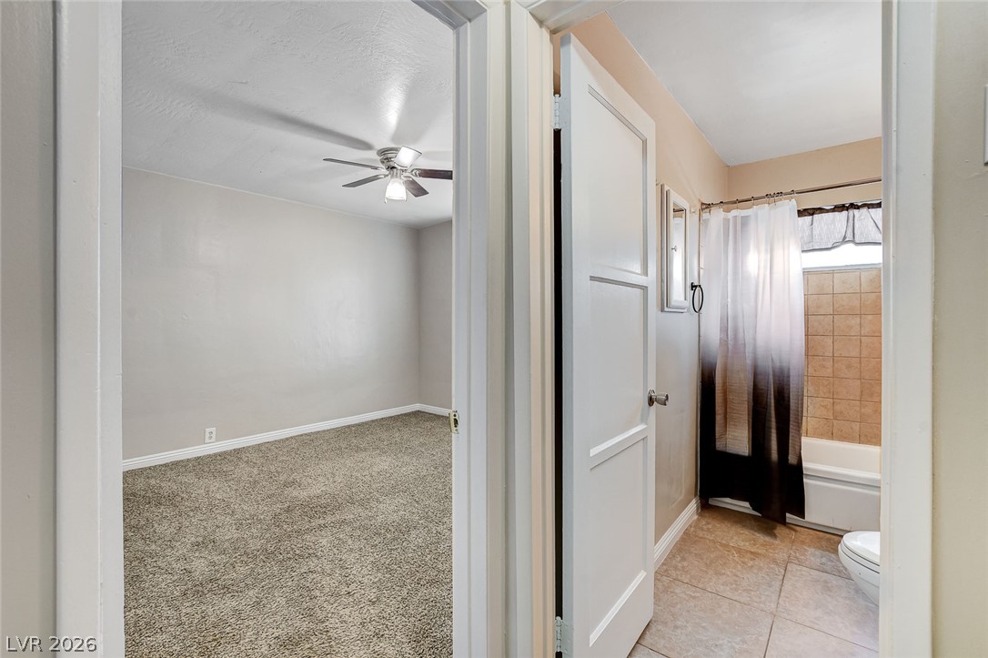 214 West Victory Road Henderson, NV 89015 - Photo 14 of 33 Functional design connects a comfortable bedroom to an adjoining bathroom for practical living.