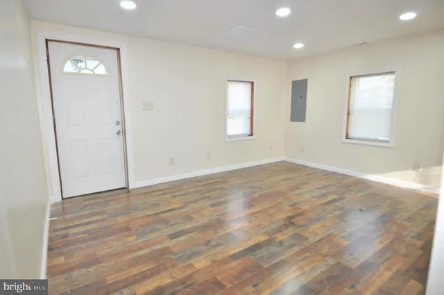 an empty room with windows and closet