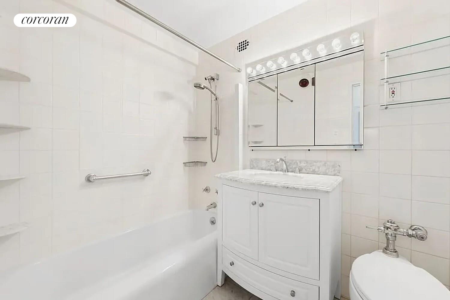 40 East 78th Street, Unit 10B Manhattan, NY 10075 - Photo 3 of 9 a bathroom with a granite countertop sink a toilet and shower