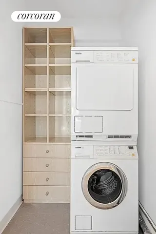 a kitchen with stainless steel appliances a stove a sink a refrigerator wooden floor and cabinets