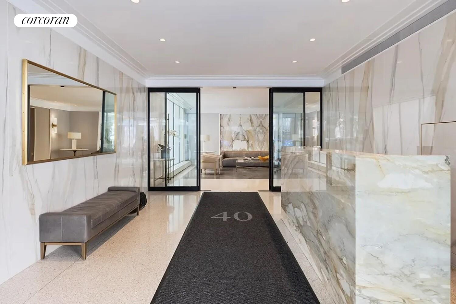 40 East 78th Street, Unit 10B Manhattan, NY 10075 - Photo 7 of 9 a lobby with furniture and large window