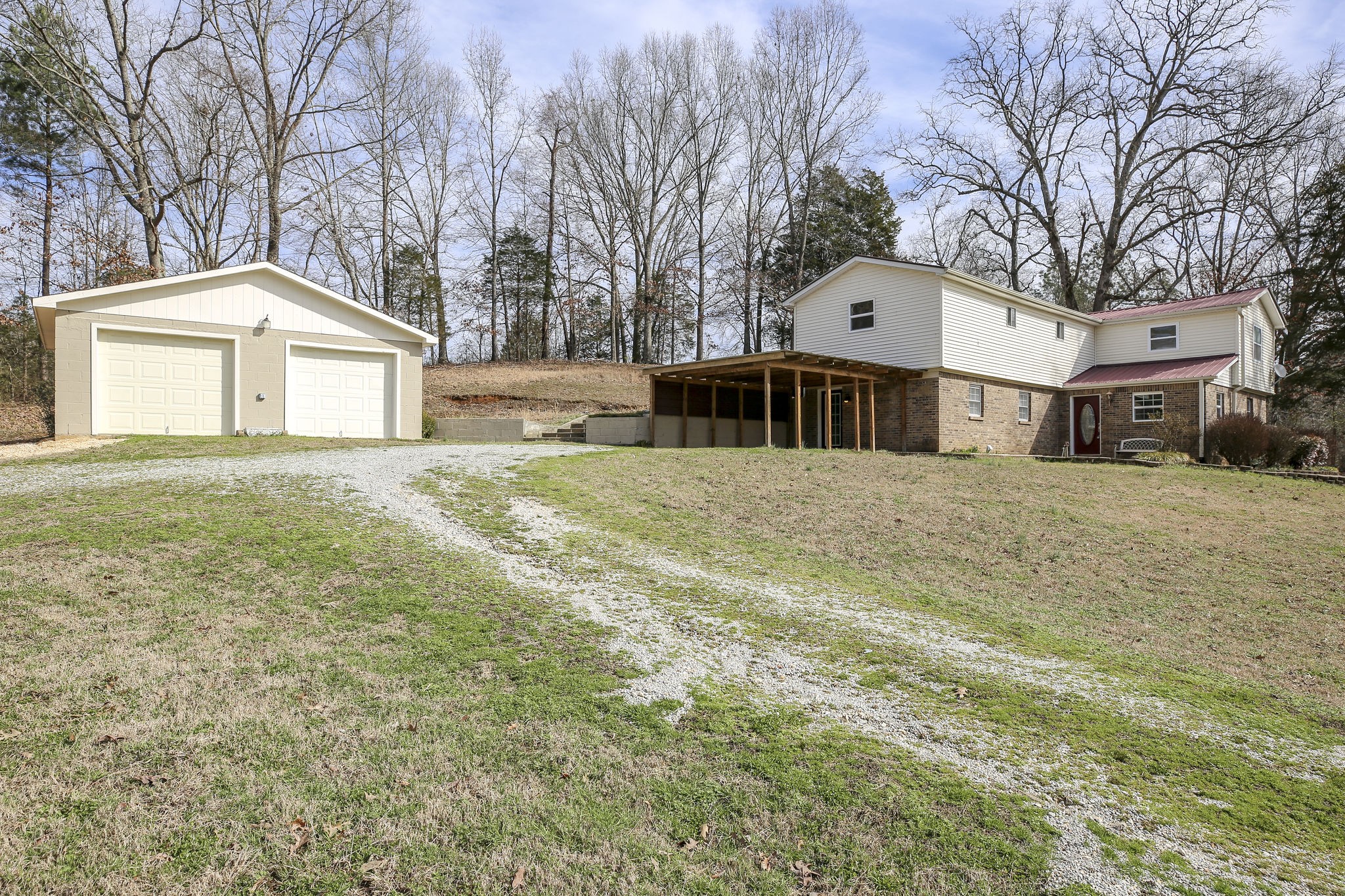 335 Eva Harbor Road Eva, TN 38333 - Photo 1 of 32 a front view of a house with a yard and garage