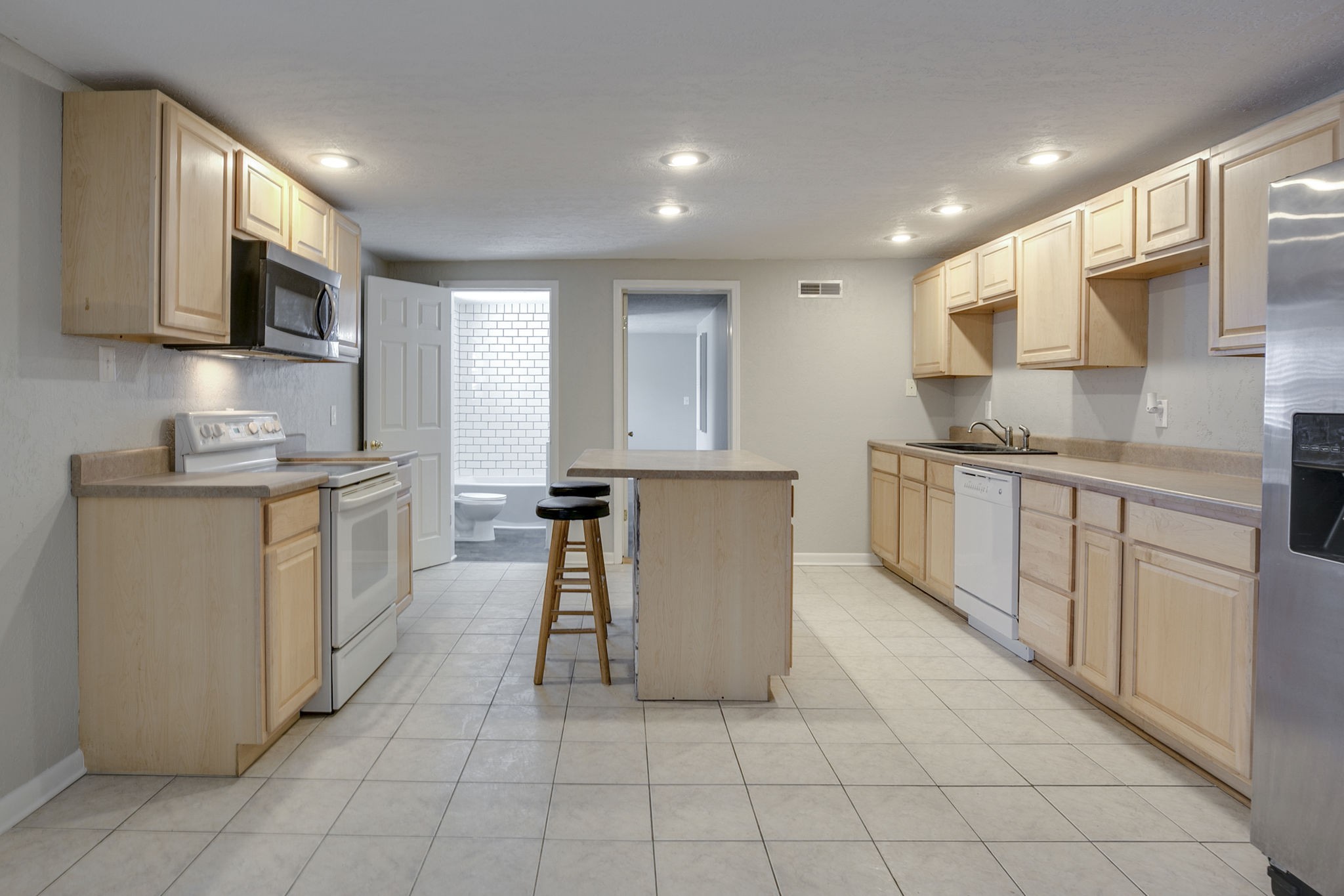 335 Eva Harbor Road Eva, TN 38333 - Photo 12 of 32 a kitchen with cabinets and chairs