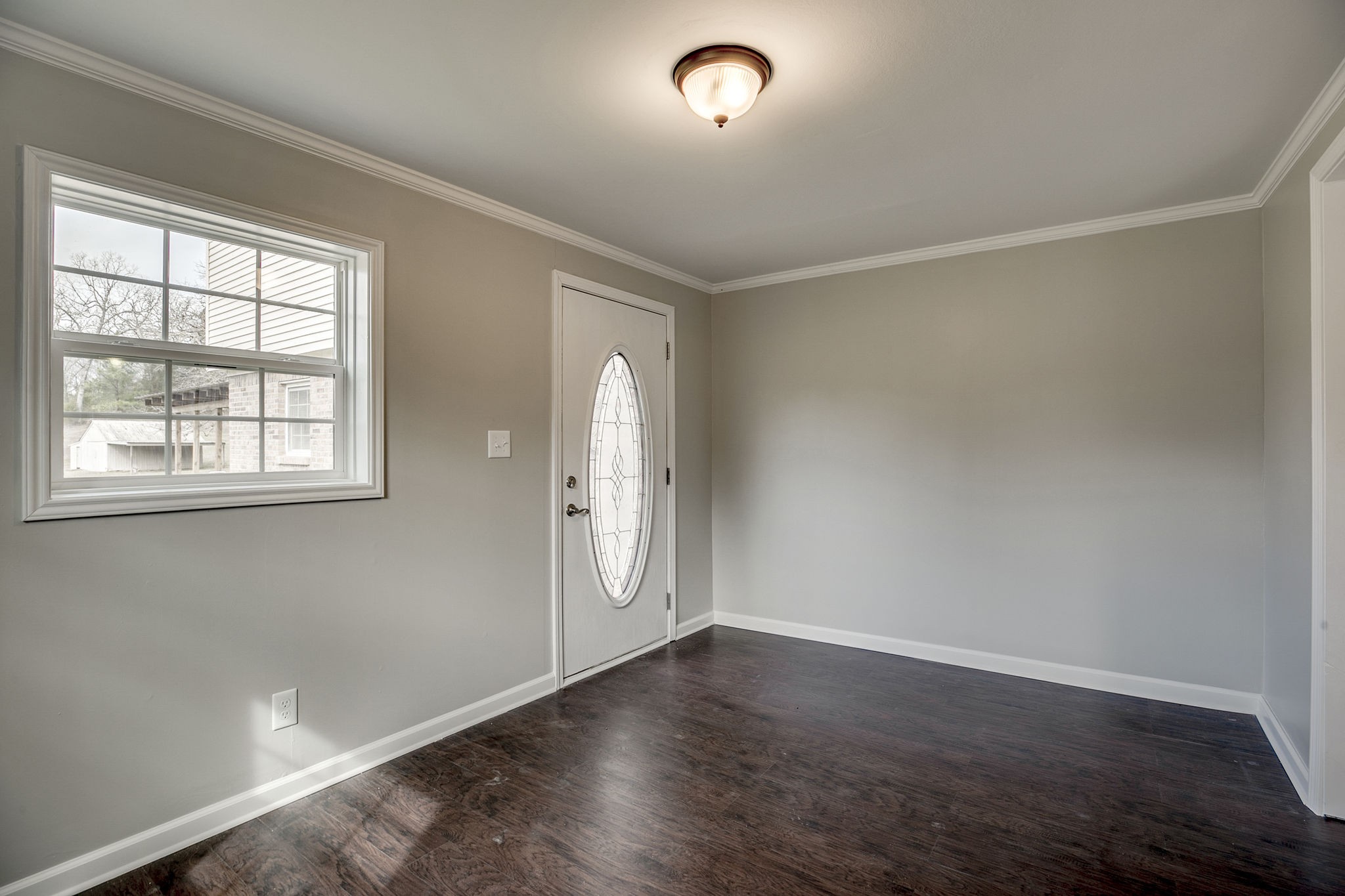 335 Eva Harbor Road Eva, TN 38333 - Photo 7 of 32 an empty room with wooden floor and windows